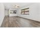 Spacious living room with open kitchen view, light-grey flooring, and a ceiling fan at 13250 Ridge Rd # 2-1, Largo, FL 33778