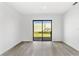 Living room with view of the outdoor patio, and light-grey wood-look flooring at 13250 Ridge Rd # 2-1, Largo, FL 33778