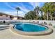 Community pool with lounge chairs and surrounding landscaping at 13250 Ridge Rd # 2-1, Largo, FL 33778