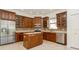 Kitchen with wooden cabinets, stainless steel appliances and an island at 17929 Timber View St, Tampa, FL 33647