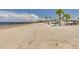 Long beach with palm trees and canopies at 3960 Headsail Dr, New Port Richey, FL 34652