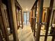 Hallway under renovation revealing stud framing and tile floors leading to bathroom at 3960 Headsail Dr, New Port Richey, FL 34652