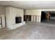 Living room with a painted brick fireplace, tile flooring, and ready for renovation at 3960 Headsail Dr, New Port Richey, FL 34652
