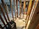 Interior view of a room torn down to the studs, exposed tile flooring at 3960 Headsail Dr, New Port Richey, FL 34652
