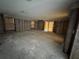 Spacious room showcasing the stud framing for walls, windows, and sliding door to outdoors at 3960 Headsail Dr, New Port Richey, FL 34652