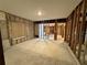 An empty room torn down to the studs, concrete floor, and exposed window at 3960 Headsail Dr, New Port Richey, FL 34652