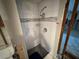 An unfinished shower with gray tile surround and new shower head at 3960 Headsail Dr, New Port Richey, FL 34652