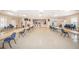 Spacious meeting room with tables, chairs, and a stage at 5400 Lemon Tree N Ln, Pinellas Park, FL 33782