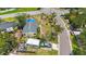 The aerial shot shows a one-story home with a gray roof, complemented by palm trees and a vintage truck nearby at 8474 Tobay N Rd, St Petersburg, FL 33702