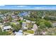 Explore waterfront living with this house nestled in a neighborhood with canals and lush greenery from this aerial view at 8474 Tobay N Rd, St Petersburg, FL 33702