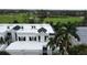 Aerial view of home showcasing the building's exterior, landscaping, and golf course location at 921 Osceola Rd, Belleair, FL 33756