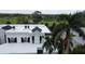 Luxury condo building with a view of the golf course and pond at 921 Osceola Rd, Belleair, FL 33756