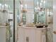 Lavish bathroom with mirrored walls and crystal chandeliers at 921 Osceola Rd, Belleair, FL 33756