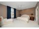 Spacious bedroom with large window, plush carpet, and a seating area at 921 Osceola Rd, Belleair, FL 33756