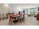 Formal dining room with a large wood table and comfortable seating for six at 921 Osceola Rd, Belleair, FL 33756