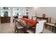 Elegant formal dining room with a large table and hardwood floors at 921 Osceola Rd, Belleair, FL 33756