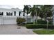 Stunning two-story home with attached garage and lush landscaping at 921 Osceola Rd, Belleair, FL 33756