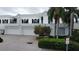 Stunning two-story home with a white facade and two-car garage at 921 Osceola Rd, Belleair, FL 33756