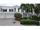 Beautiful two-story home with attached garage and lush landscaping at 921 Osceola Rd, Belleair, FL 33756
