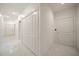 Bright hallway with white doors and marble floors at 921 Osceola Rd, Belleair, FL 33756