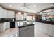 Modern kitchen with white cabinets, granite countertops, and island at 921 Osceola Rd, Belleair, FL 33756