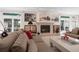 Bright living room featuring a fireplace and large windows at 921 Osceola Rd, Belleair, FL 33756