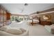 Large main bedroom with ample space, plush seating and large windows at 921 Osceola Rd, Belleair, FL 33756