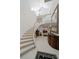 Grand curved staircase with chandelier and wrought iron railing at 921 Osceola Rd, Belleair, FL 33756