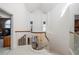 Upstairs hallway with a view of the grand staircase and chandelier at 921 Osceola Rd, Belleair, FL 33756