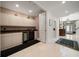 Convenient wet bar with granite countertop and mini-refrigerator at 921 Osceola Rd, Belleair, FL 33756
