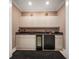 Basement wet bar with granite countertop and mini-refrigerator at 921 Osceola Rd, Belleair, FL 33756
