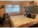 Bright bedroom with king-size bed and ample natural light at 9218 Mission Oaks Blvd # E, Seminole, FL 33776