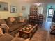 Bright living room with dining area, featuring hardwood floors at 9218 Mission Oaks Blvd # E, Seminole, FL 33776
