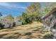 Yard with a large tree and white fence at 1008 Chester Dr, Clearwater, FL 33756