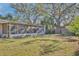 Large backyard with screened porch and mature trees at 1008 Chester Dr, Clearwater, FL 33756
