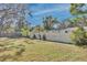 Spacious backyard with a large tree and white fence at 1008 Chester Dr, Clearwater, FL 33756