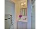 Clean bathroom with a gray vanity, mirror and a walk-in shower at 1008 Chester Dr, Clearwater, FL 33756