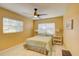 Comfortable bedroom with a ceiling fan, window blinds, and a queen bed at 1008 Chester Dr, Clearwater, FL 33756
