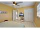 Spacious bedroom with ceiling fan, large closet, and mounted TV at 1008 Chester Dr, Clearwater, FL 33756