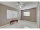 Bright bedroom with tile floors, window blinds, and a bench at 1008 Chester Dr, Clearwater, FL 33756