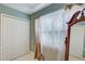 Bedroom with mirrored closet doors and window coverings at 1008 Chester Dr, Clearwater, FL 33756