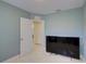 Bedroom with large TV and access to bathroom at 1008 Chester Dr, Clearwater, FL 33756