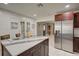 Island kitchen features stainless steel appliances and marble countertops at 1008 Chester Dr, Clearwater, FL 33756