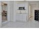 Small kitchen with white cabinets, microwave, and marble flooring at 1008 Chester Dr, Clearwater, FL 33756