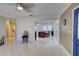 Spacious living room with tile flooring and a view into the kitchen at 1008 Chester Dr, Clearwater, FL 33756