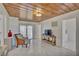 Living room features wood ceiling, tile floors, and a view to the kitchen at 1008 Chester Dr, Clearwater, FL 33756