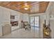 Living room with wood ceiling, tile floors and kitchen view at 1008 Chester Dr, Clearwater, FL 33756