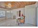 Living room with wood ceiling, tile floors, and access to other rooms at 1008 Chester Dr, Clearwater, FL 33756
