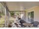 Screened porch with patio furniture and backyard access at 1008 Chester Dr, Clearwater, FL 33756