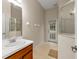 Bathroom with single sink, shower, and exterior access at 14649 Deacon Ct, Spring Hill, FL 34609